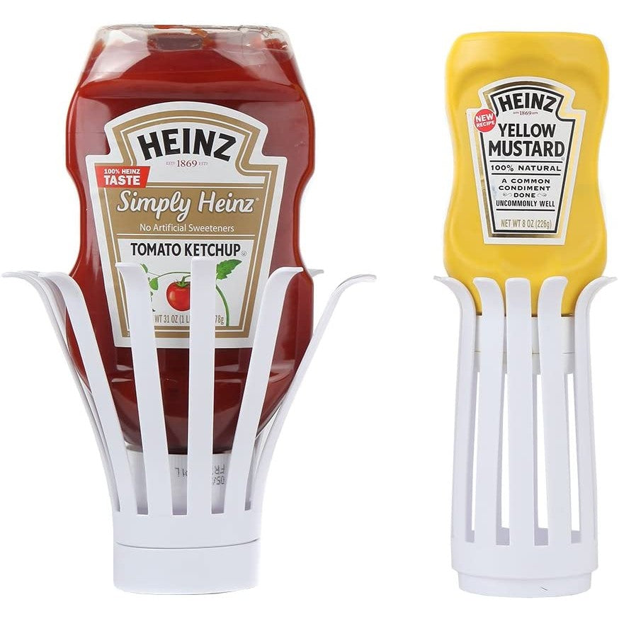 A set of two upside-down condiment bottle holders designed to draw the sauce to the bottle of the container for easy dispensing. There is ketchup in one dispenser and mustard in the other.