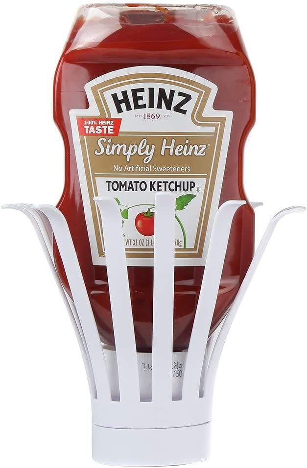 An upside-down condiment bottle holder with a bottle of tomato ketchup in it. The holders help draw the sauce to the bottom of the container so it can be easily dispensed.