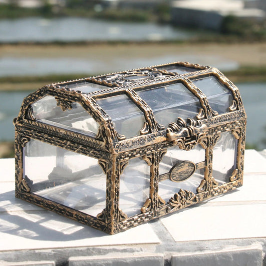A small old fashioned pirates treasure chest made from glass and metal used for storage.