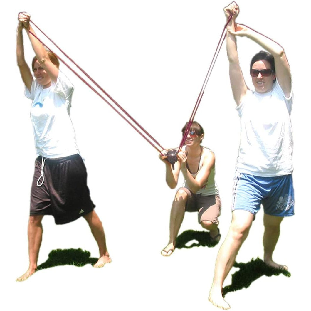 Three people preparing a large water balloon slingshot launcher