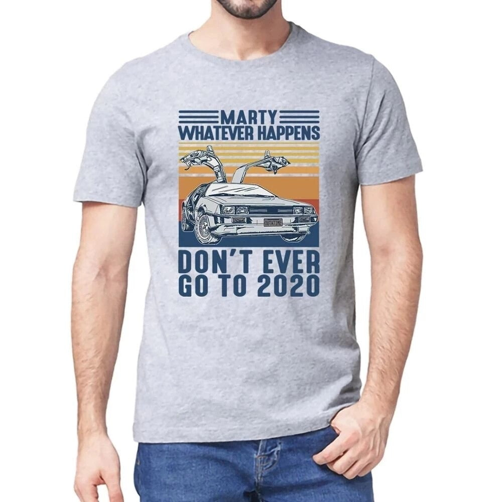 A male wearing a grey Back To The Future t-shirt which says, Marty Whatever Happens Don't Ever Go To 2020