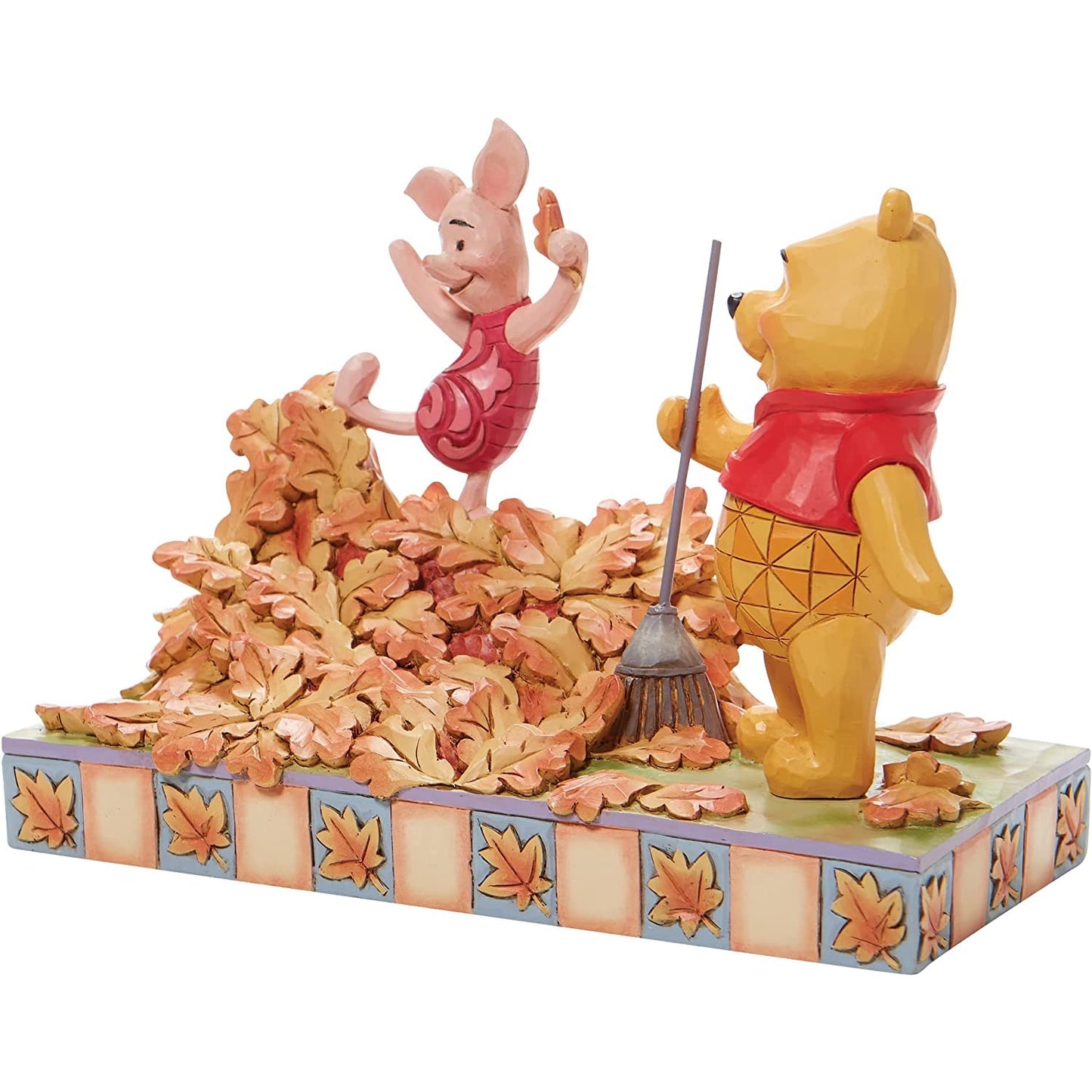 A figurine of Winnie The Pooh and Piglet.