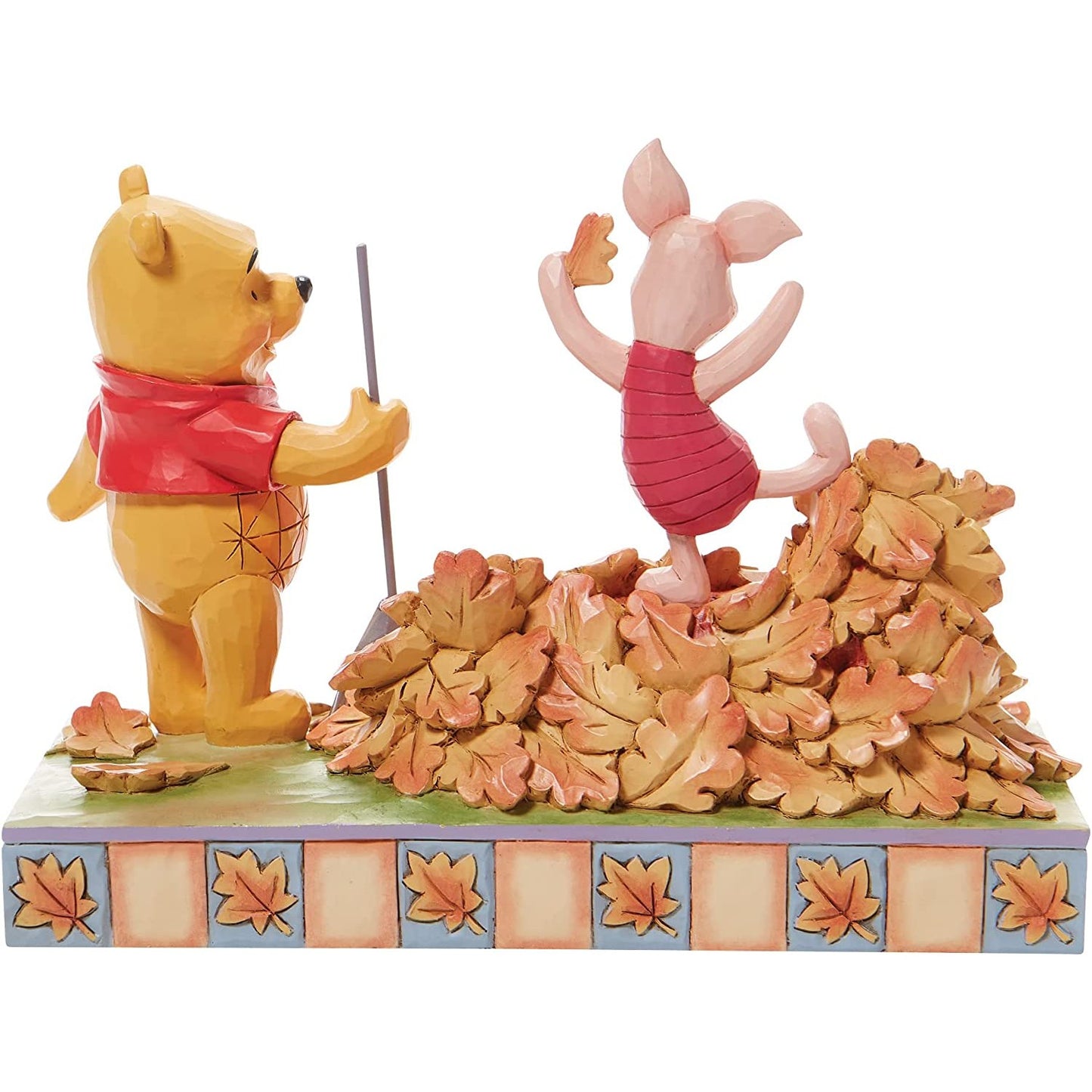 A figurine of Winnie The Pooh and Piglet.